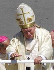 The Pope waves to a croud below (www.corbis.com)