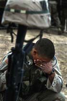 Specialist Jesse Blancarte of Frostproof, Florida, fights back tears at a memorial service for Private Gregory Huxley Jr., 19, of Forest Port, New York (www.corbis.com)