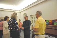 Joe Graedon talks with people after the program that he and his wife, Terry held on September 22 about homeopathic medicine and their long-running NPR show (Lori Hendrickson)