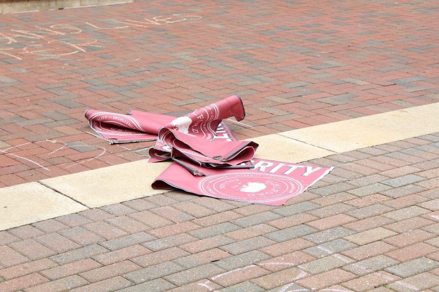 Students leave two of the Core Value flags in front of Founders Hall after taking them down from the quad.