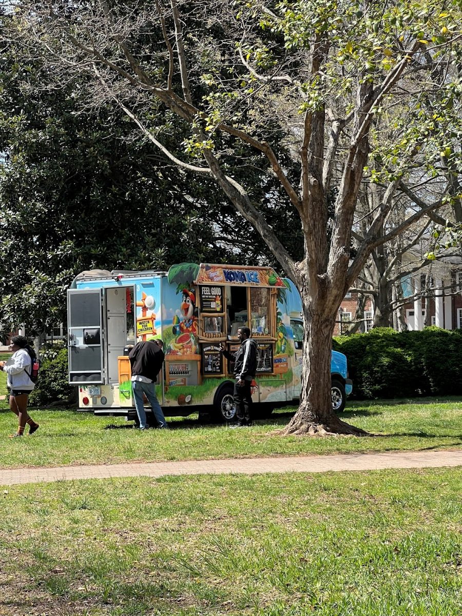 As the temperature rose into the mid-70s, students and volunteers working on setting up tables around Founders Hall cooled off with cups of shaved ice from a Kona Ice truck stationed directly outside the building.
