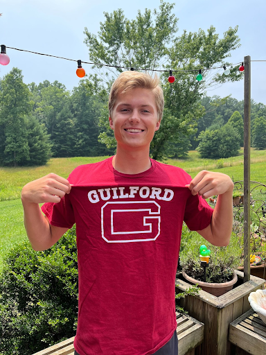 GSBA president Jacob Mitchell flexing his Guilford College merch, highlighting the passion he finds so key to the school's success.